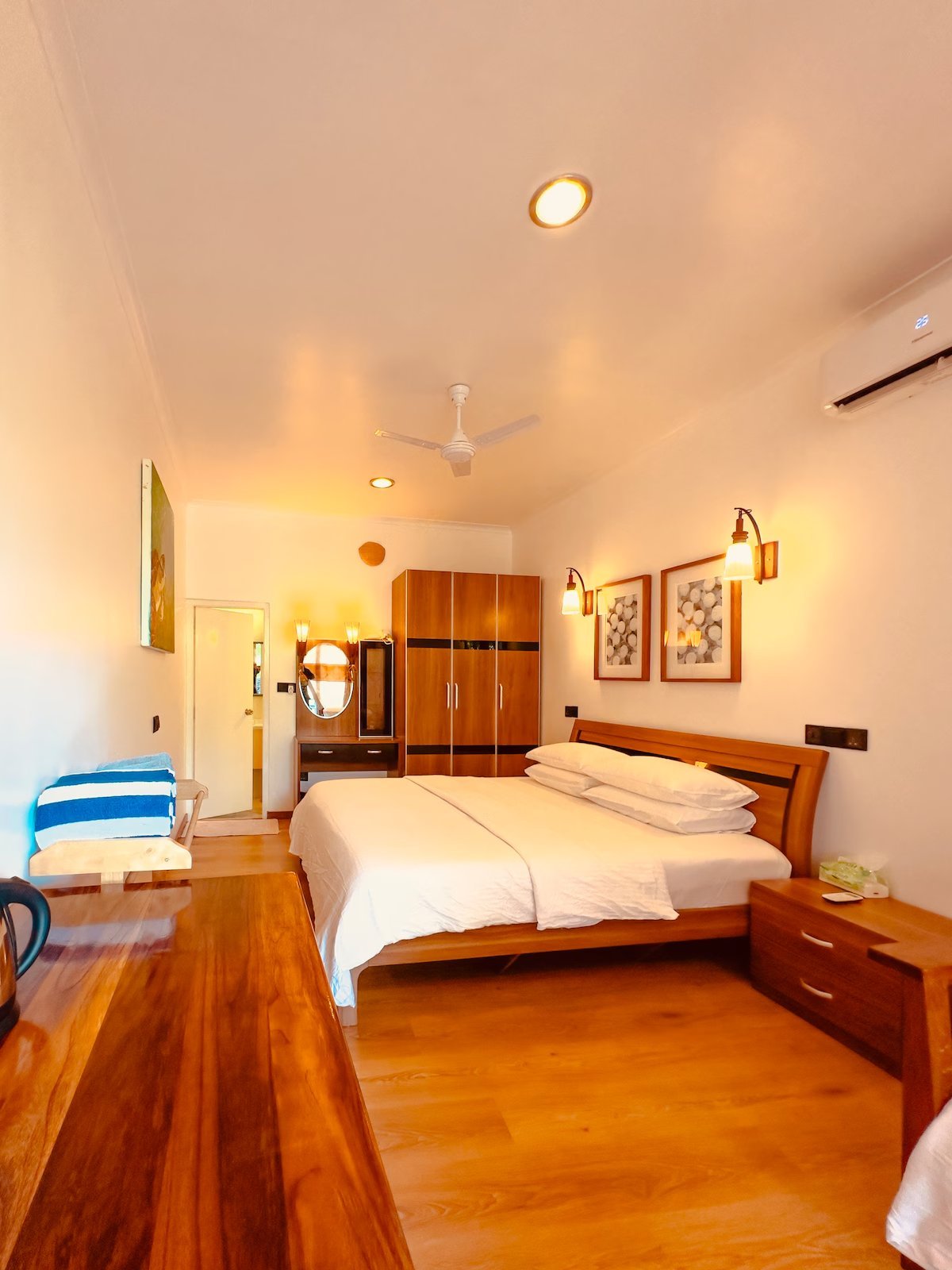 Guest room with double bed in warm evening light